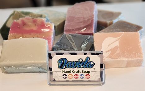 Davida handmade soap bars on display with a Davida business card
